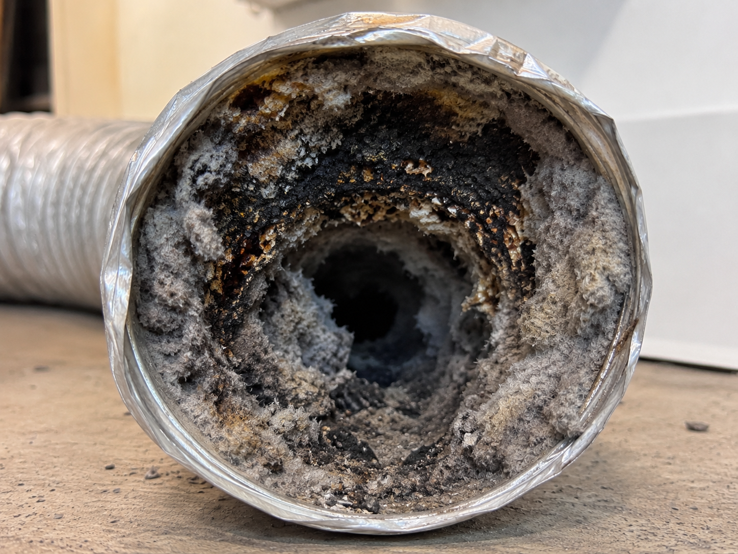 Dryer vent cleaning technician at work